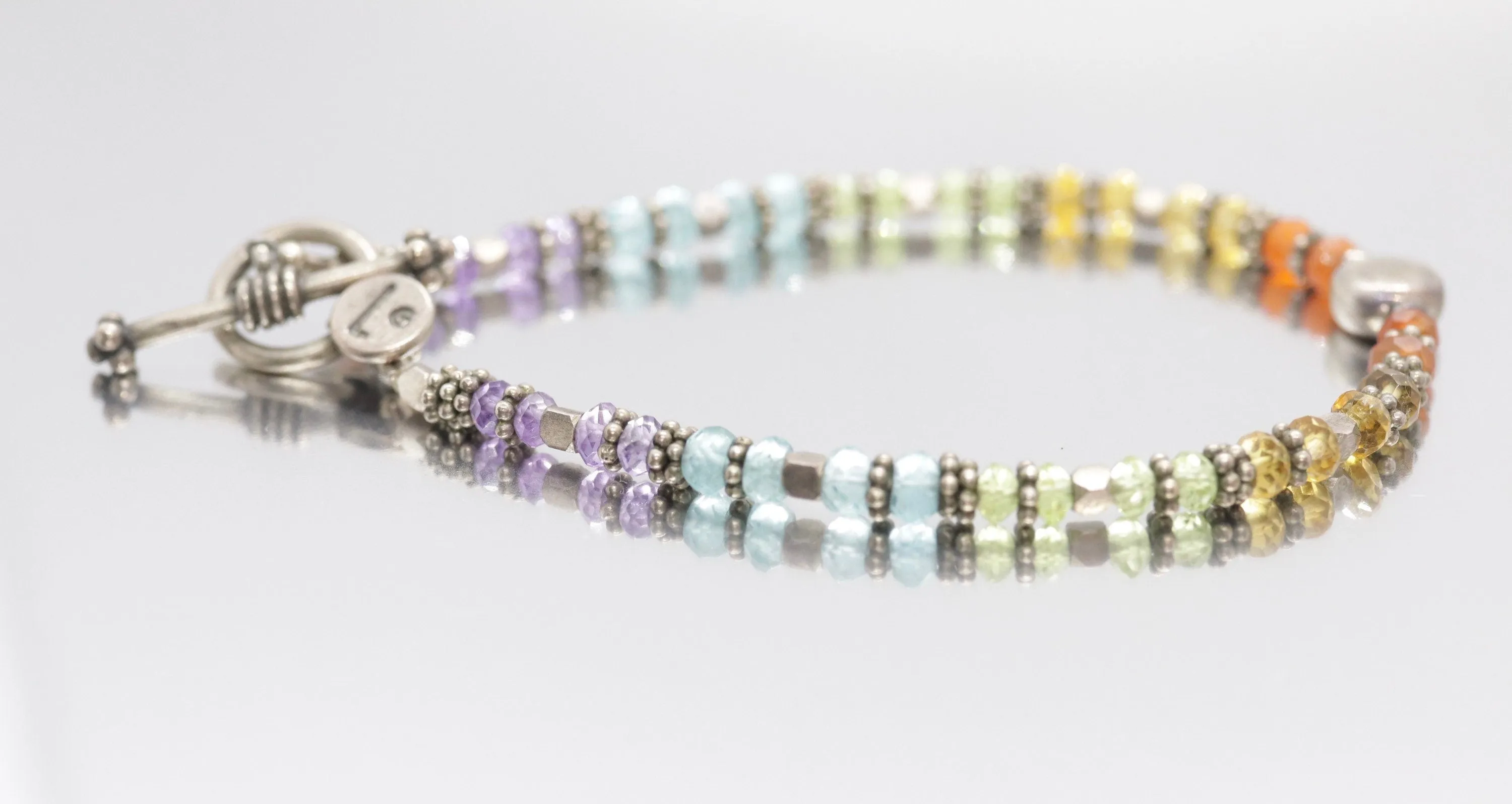 Laura Gibson Bracelet. Sterling Silver with Dangling Faceted Gems - (298)
